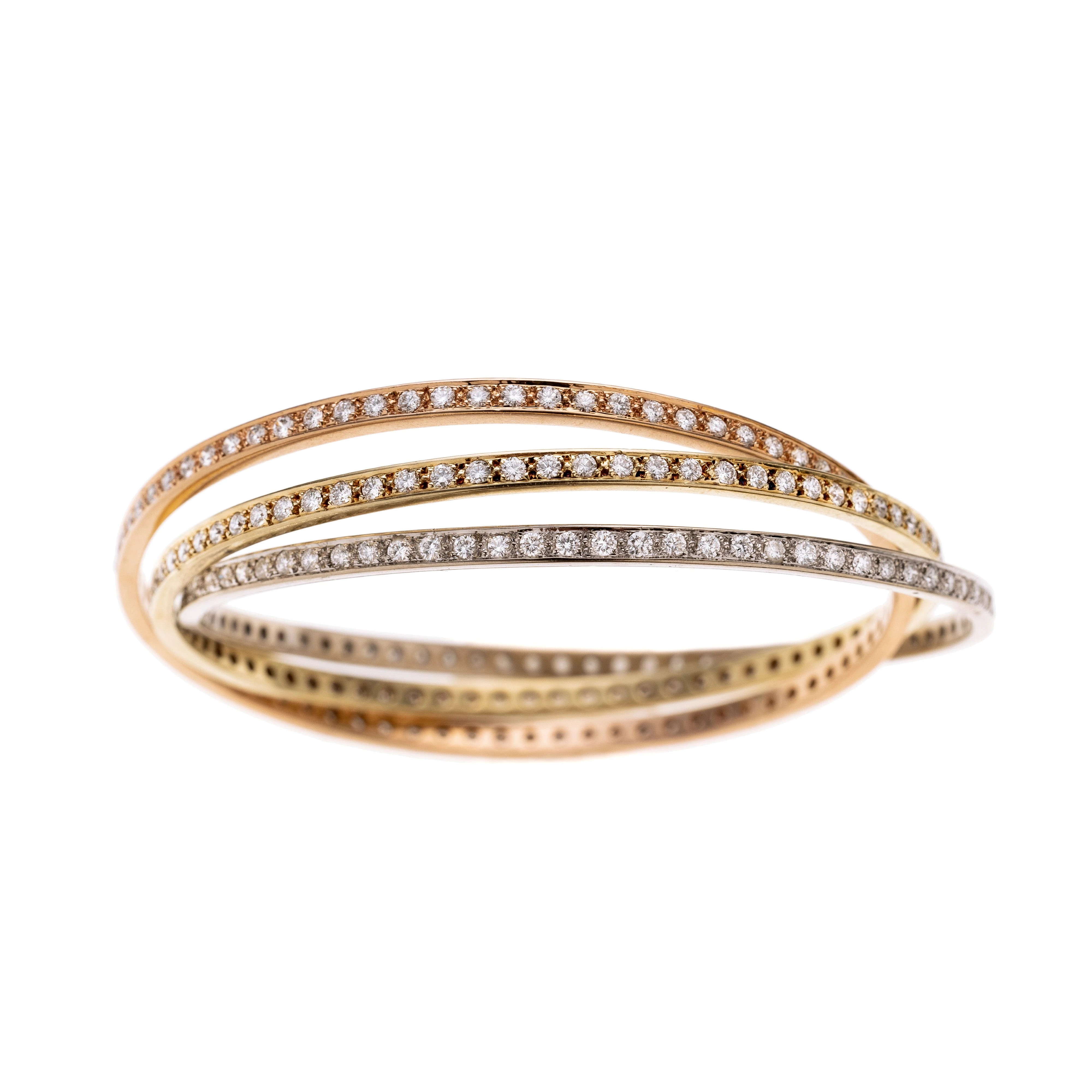 Ein Dreierreif tricolor, besetzt mit insgesamt 225 Diamanten je ca. 0.02 ct