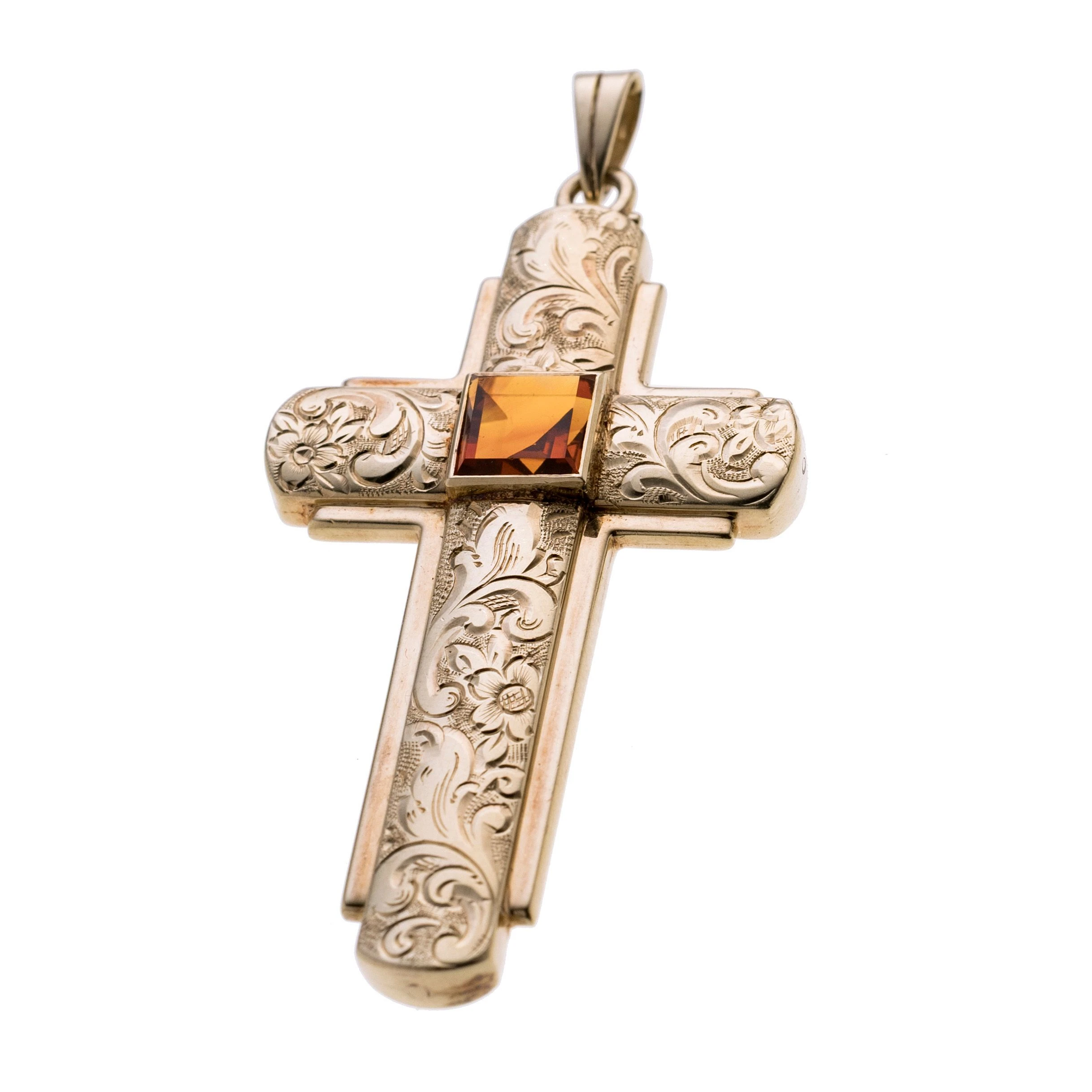 Ein Kreuz mit floralen Gravierungen und mittig einem Citrin