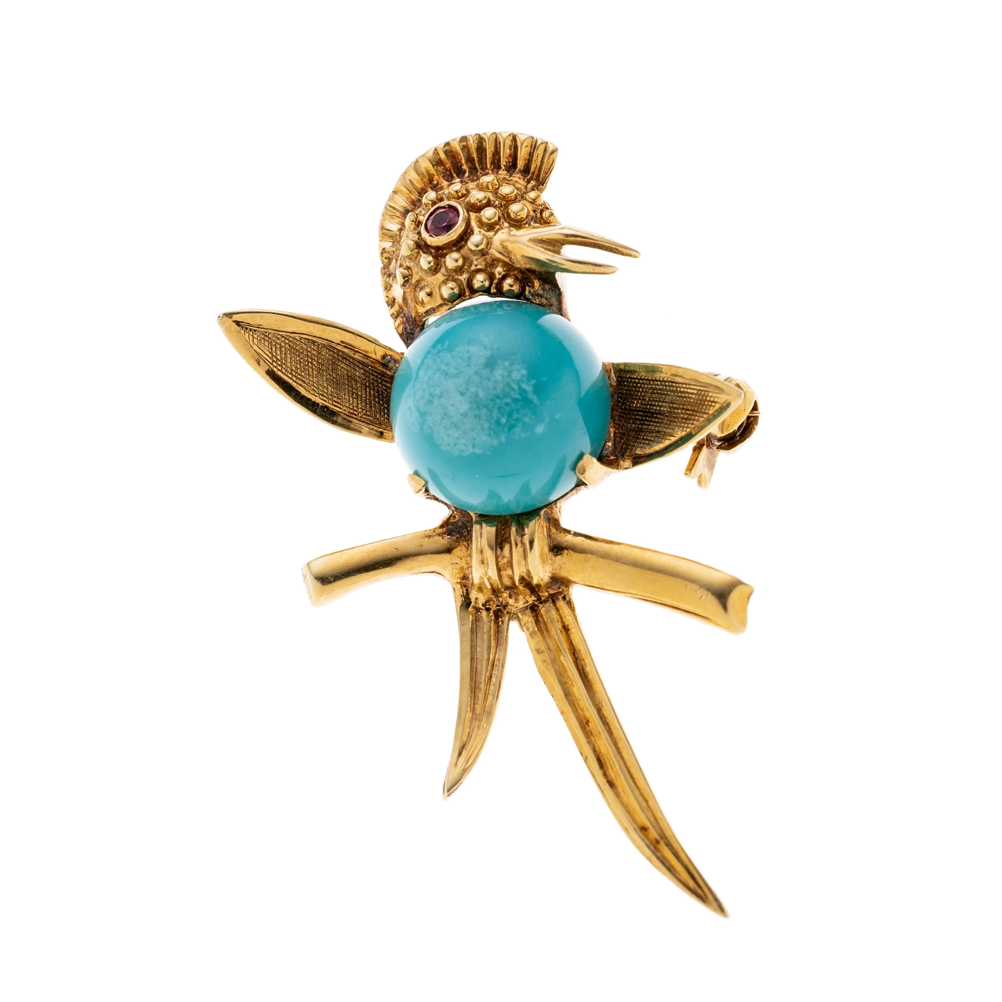 Ein Vogel mit Rubin als Auge und einem runden Türkis-Cabochon als Körper, auf einem Ast.