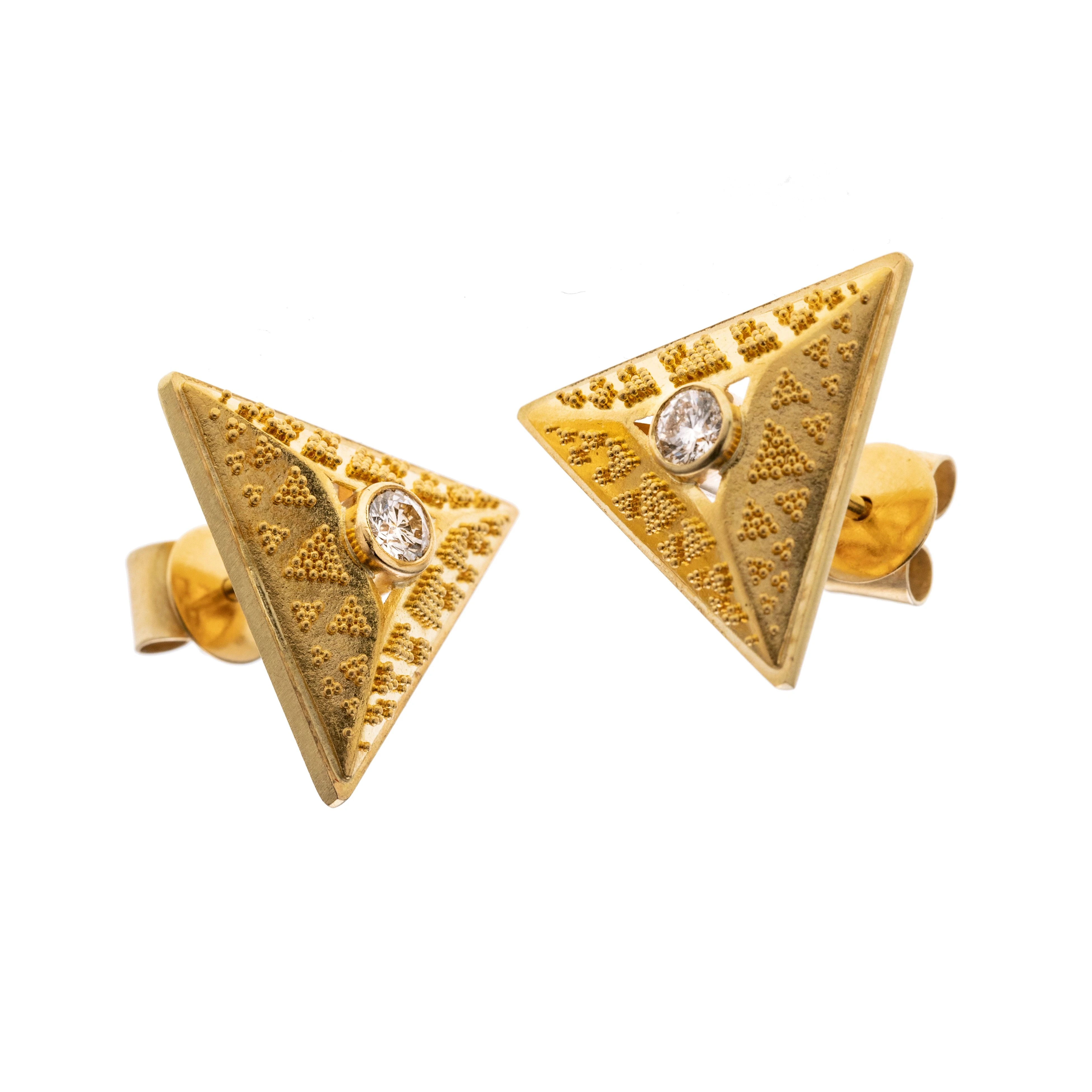 Erhabene Dreiecke mit Granullation mit jeweils einem ca. 0.15 ct Brillanten in der Mitte.